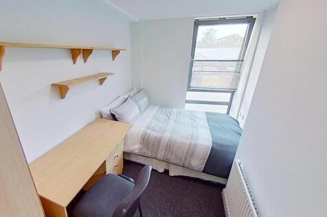 Spacious double bedroom featuring a comfortable...