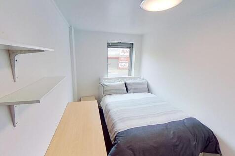 Cozy double bedroom featuring a comfortable bed...