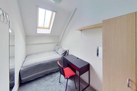 This charming double bedroom features a cozy be...