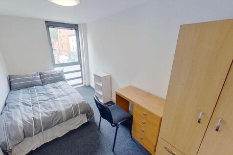 This inviting double bedroom features a comfort...