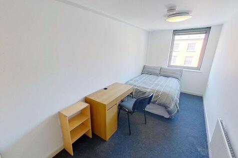 This inviting double bedroom features a comfort...