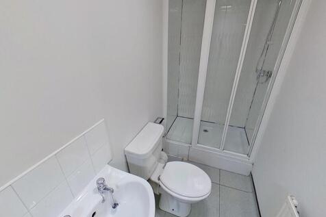 A modern bathroom featuring a sleek shower encl...