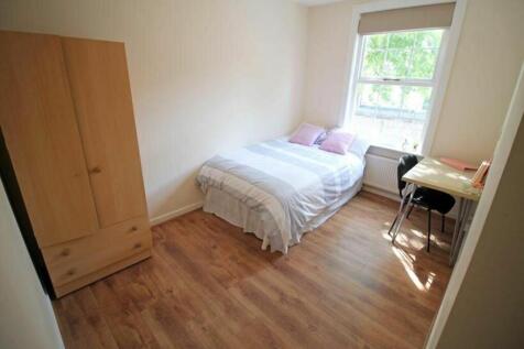 This inviting double bedroom features a cozy be...