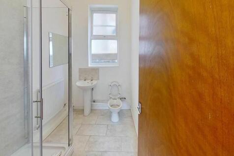 Spacious bathroom featuring a modern shower, el...