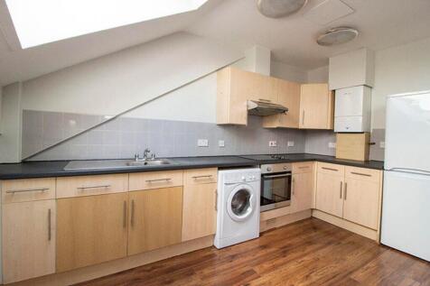Modern kitchen featuring sleek cabinetry, ample...