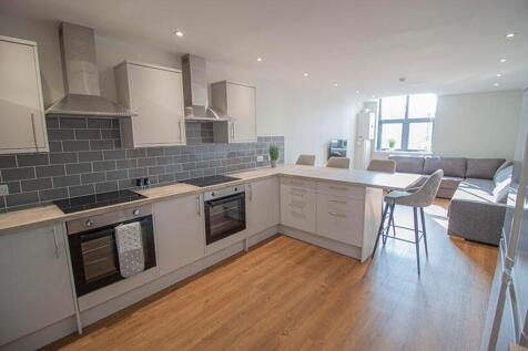 Modern kitchen featuring sleek cabinetry, ample...