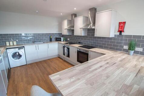 Modern kitchen equipped with sleek cabinetry, a...