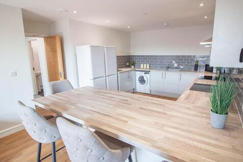 This modern kitchen features a spacious layout ...