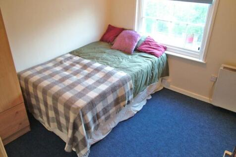 Cozy double bedroom featuring a comfortable bed...