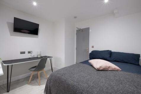 This inviting double bedroom features a cozy be...