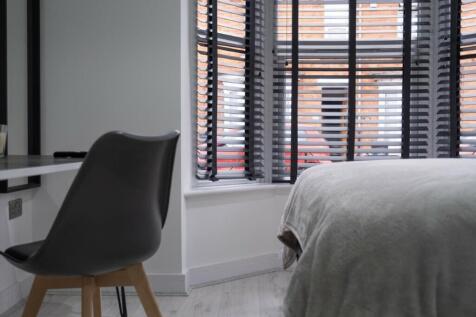 A cozy double bedroom featuring stylish decor, ...