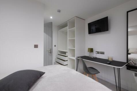 A stylish double bedroom featuring a comfortabl...