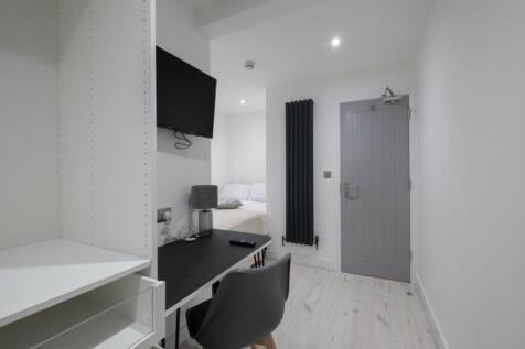 A stylish double bedroom featuring a comfortabl...