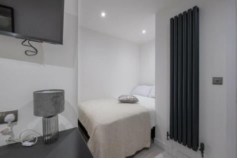 Cozy double bedroom featuring a comfortable bed...