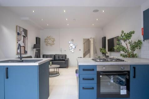 Bright and modern kitchen featuring sleek cabin...