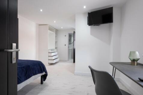 A bright and modern double bedroom featuring am...