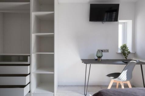 A stylish and modern double bedroom featuring a...