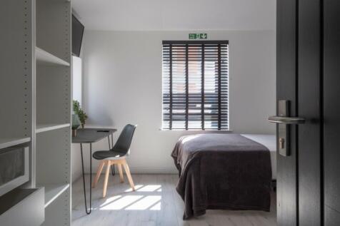 A bright and inviting double bedroom with moder...