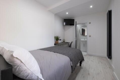 A bright and inviting double bedroom with moder...