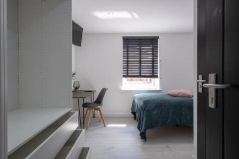 A bright and inviting double bedroom featuring ...