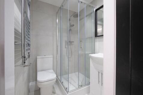 A modern and pristine bathroom featuring a spac...