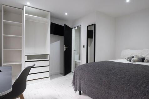 This stylish double bedroom features a cozy lay...