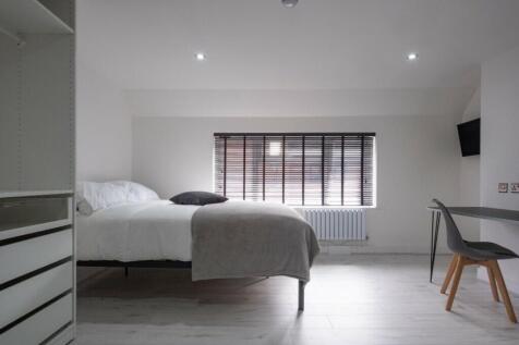 Bright and spacious double bedroom featuring a ...