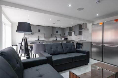 A modern kitchen featuring sleek cabinetry, amp...