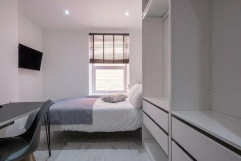 This inviting double bedroom features a comfort...