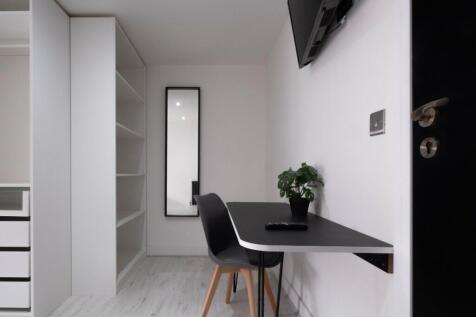 A bright and inviting communal workspace featur...