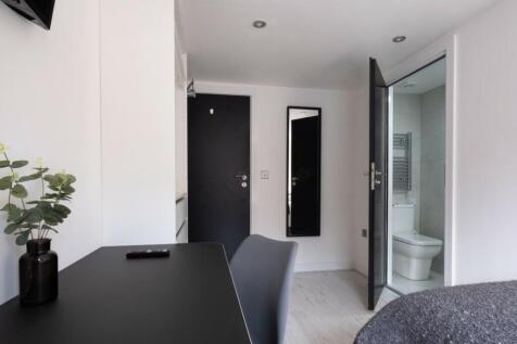 Bright and modern bathroom featuring sleek fixt...