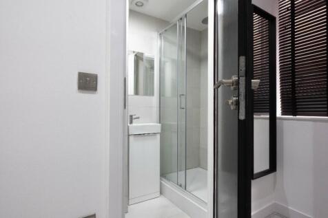 Modern bathroom featuring a sleek shower enclos...