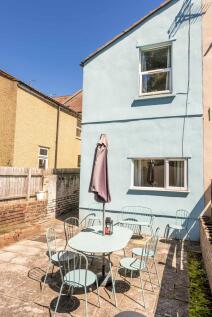 A charming outdoor garden area featuring a spac...