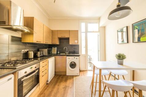 A modern and well-equipped kitchen featuring sl...