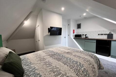 This charming double bedroom features a cozy am...