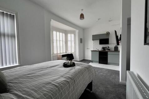 This stylish double bedroom features a comforta...