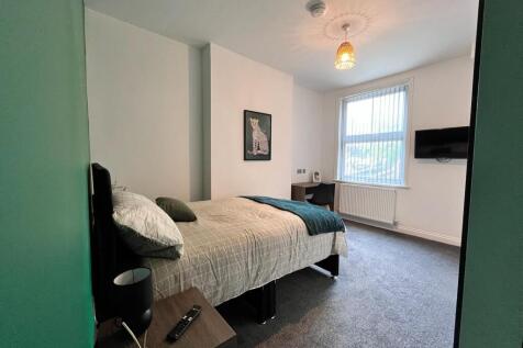 A spacious and inviting double bedroom featurin...