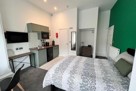 This inviting double bedroom features a modern ...