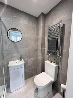 Modern and stylish bathroom featuring sleek til...