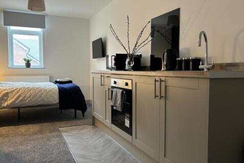 This stylish double bedroom features a cozy lay...