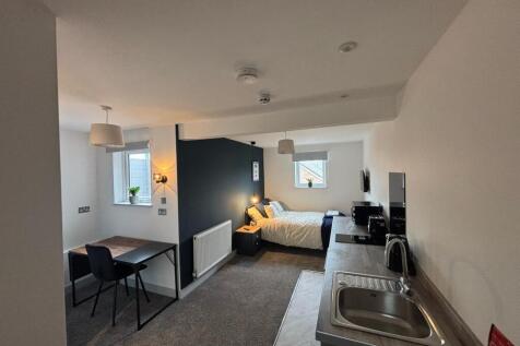 This cozy double bedroom features a well-lit sp...