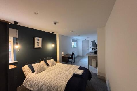 This inviting double bedroom features a stylish...