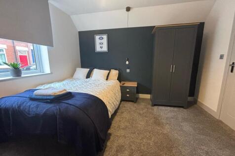 This charming double bedroom features a cozy la...