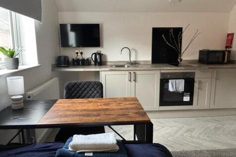 This modern kitchen area features stylish cabin...