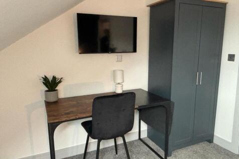 This stylish communal workspace features a mode...