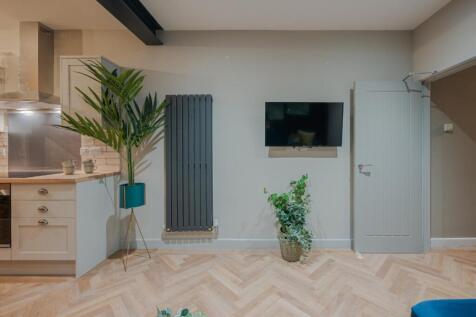 A stylish and contemporary living room featurin...