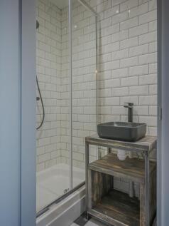 Modern bathroom featuring sleek design with a s...