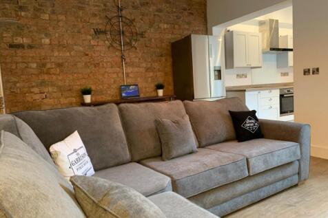 This inviting living room features a spacious l...