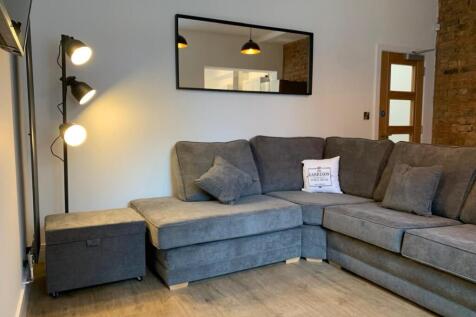 This stylish living room features a contemporar...