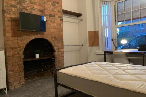 Charming double bedroom featuring a cozy atmosp...